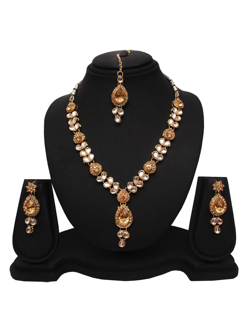 Golden Alloy Austrian Diamonds Necklace With Earrings and Maang Tikka 89181